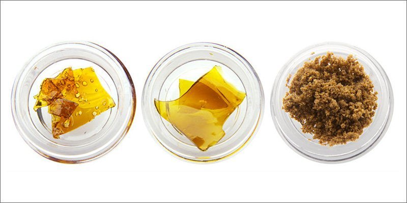 three different wax concentrates for vaping laid out in glass jars