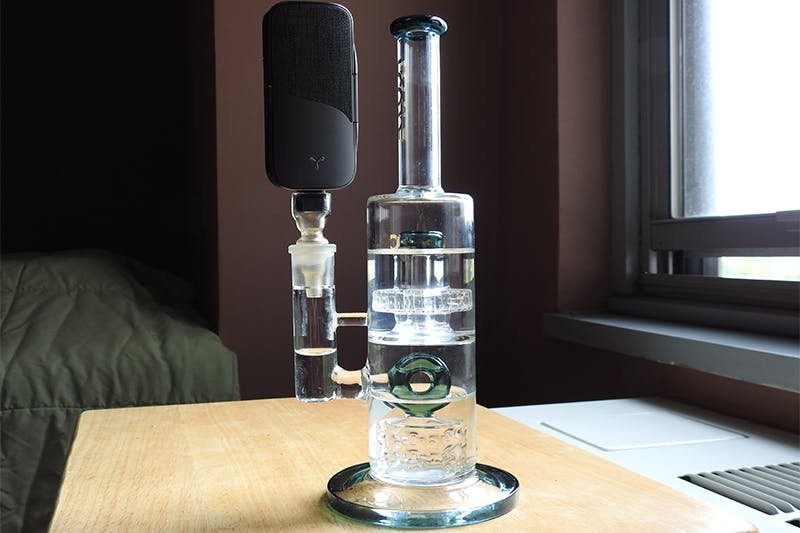 Premium Photo  Vertical shot of bong and pipe filled with weed set of  accessories for smoking cannabis marijuana